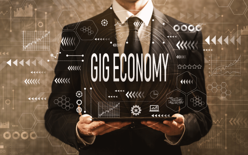 An image of a professional in suit and tie with the word "Gig Economy" at the center in the line with the context of the blog discussing the best cash advance for gig workers