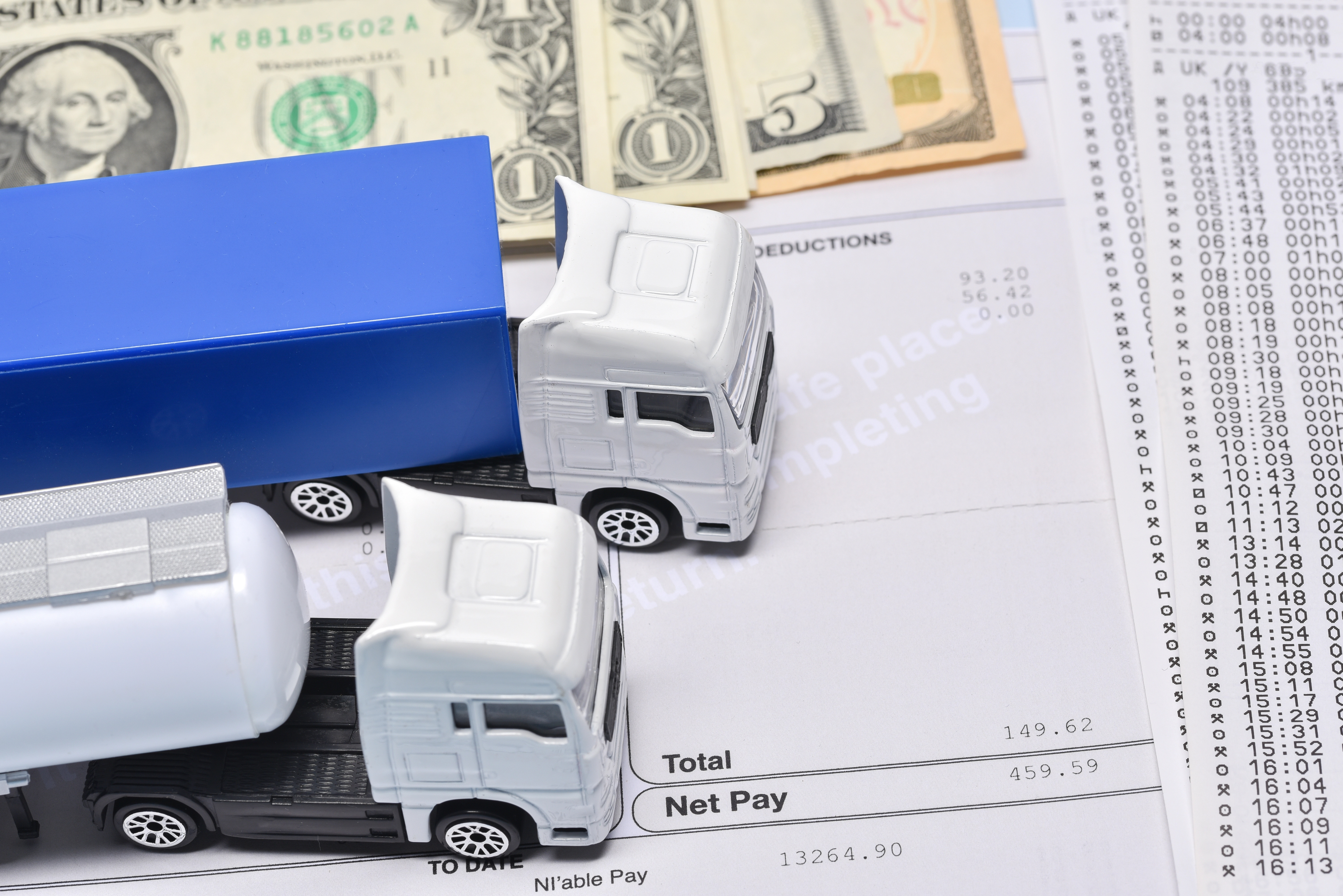 A concept of a paper with loans amount and cash and truck toy.