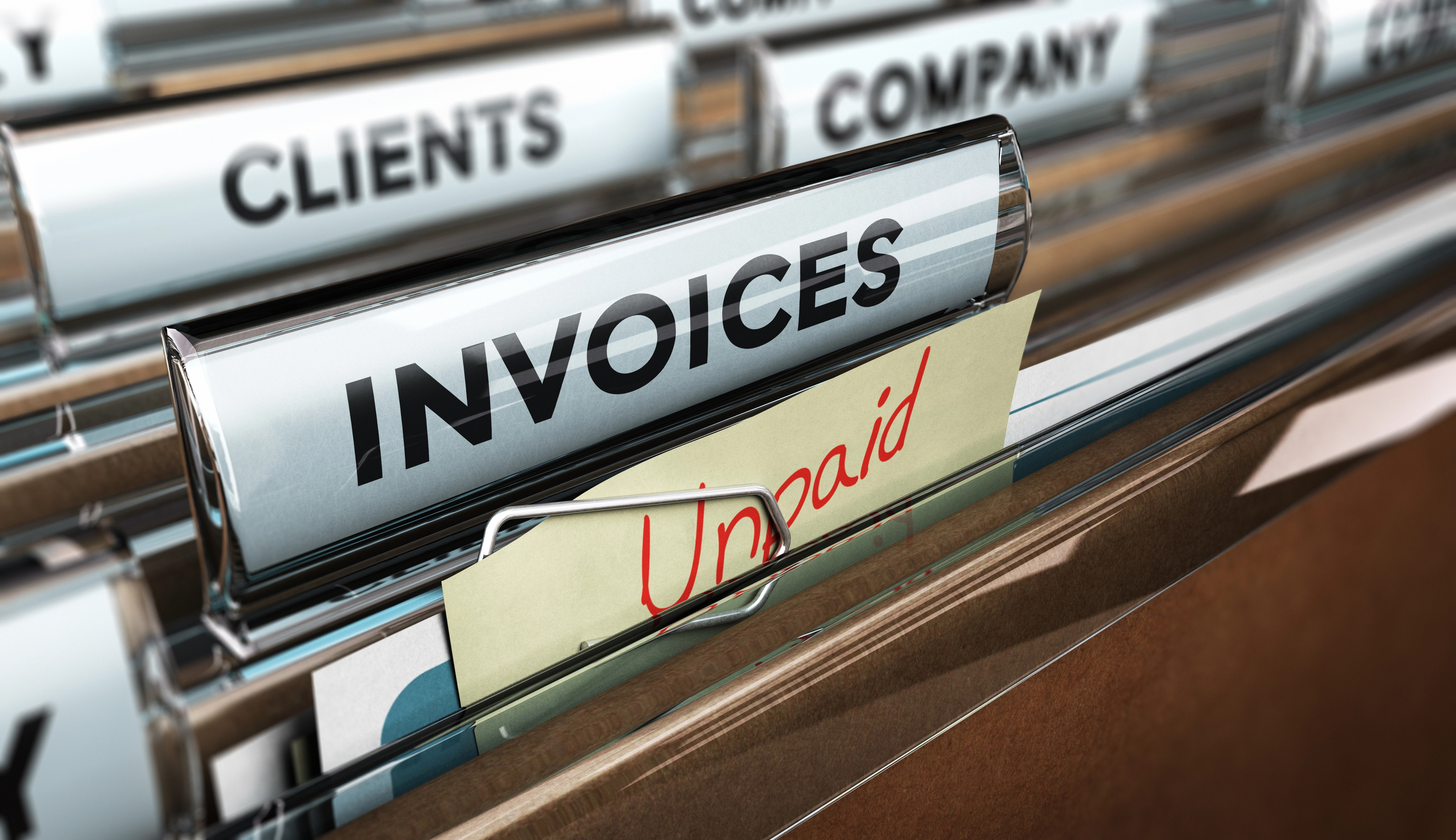 A tab of files one invoices with a sticky note that says unpaid