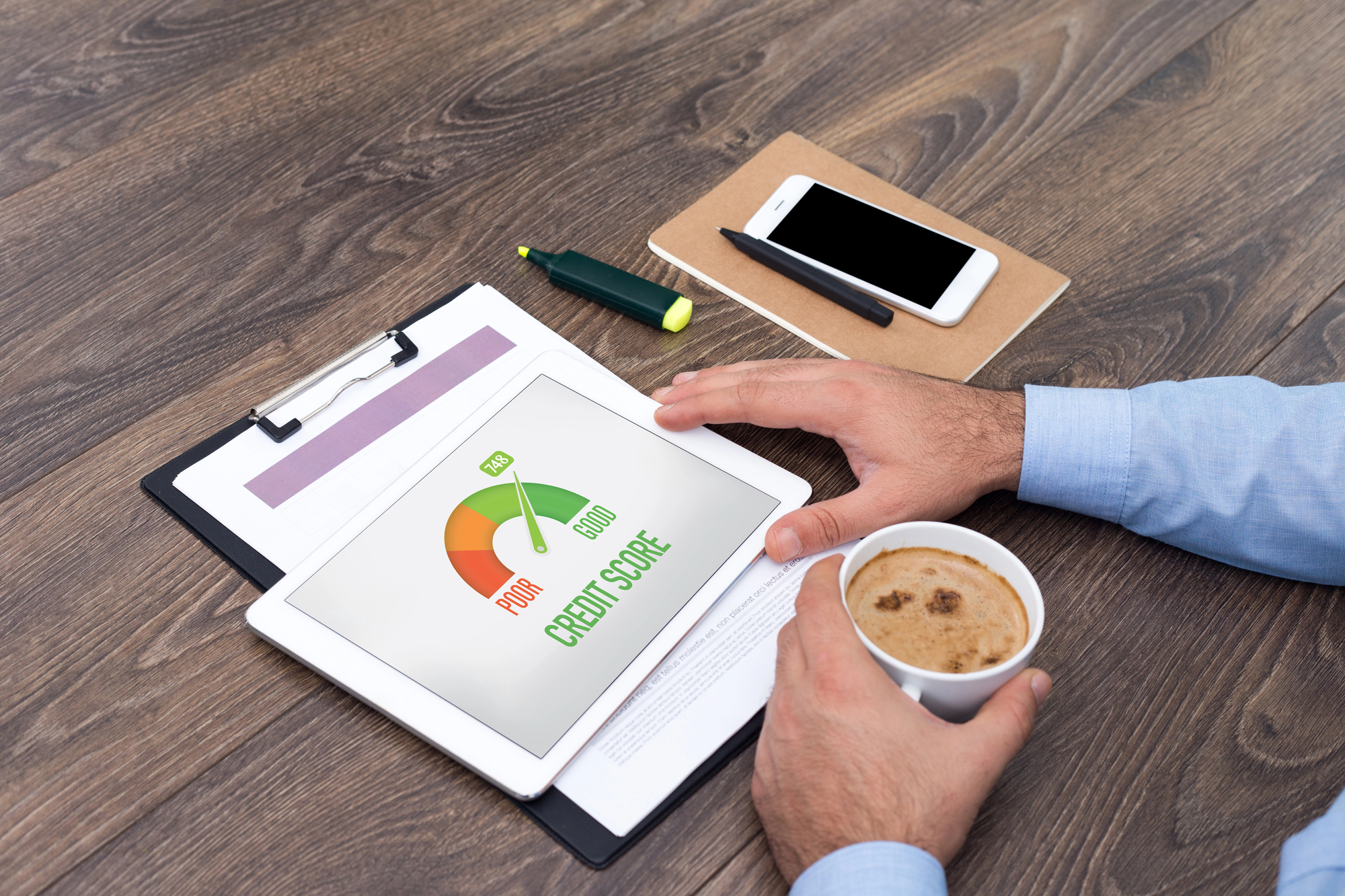 a self-employed worker checking their credit score while drinking coffee