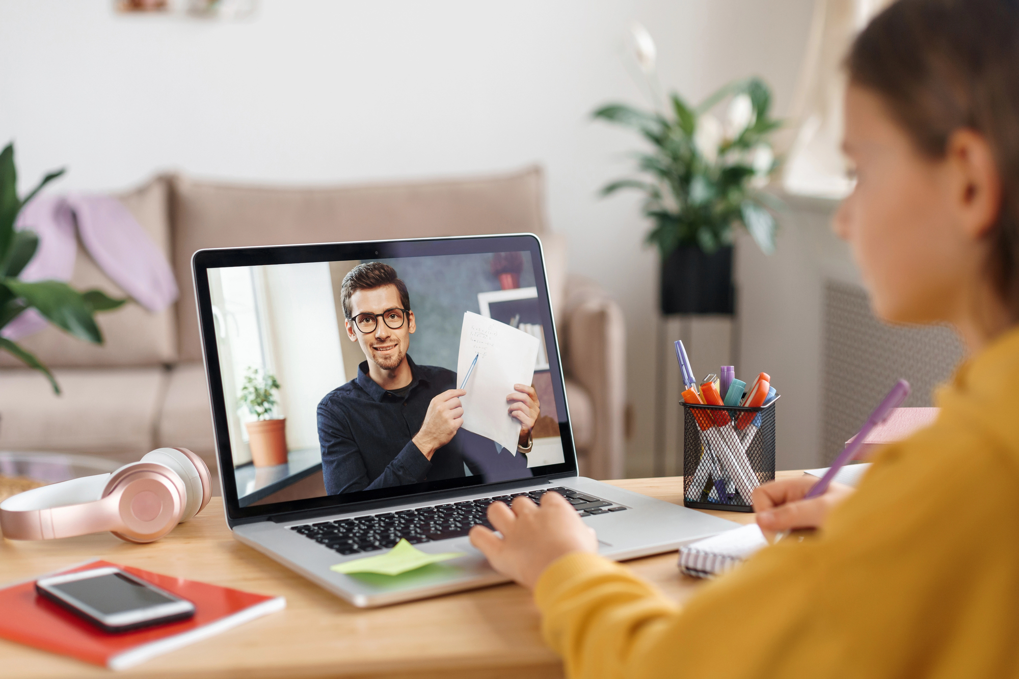 a student attending an online class with a freelance teacher