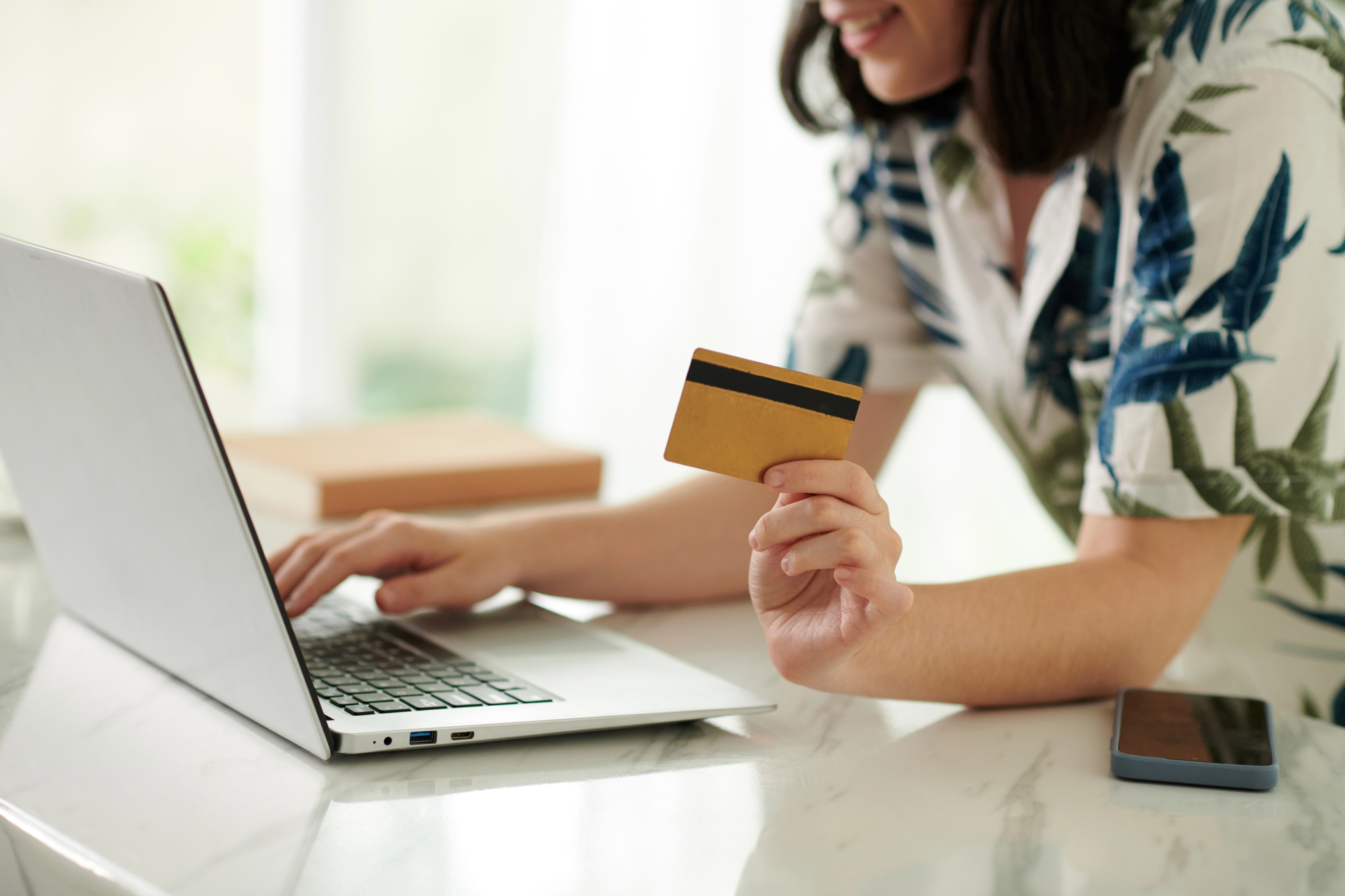 woman excited to purchase from an online Amazon storefront while holding her credit card