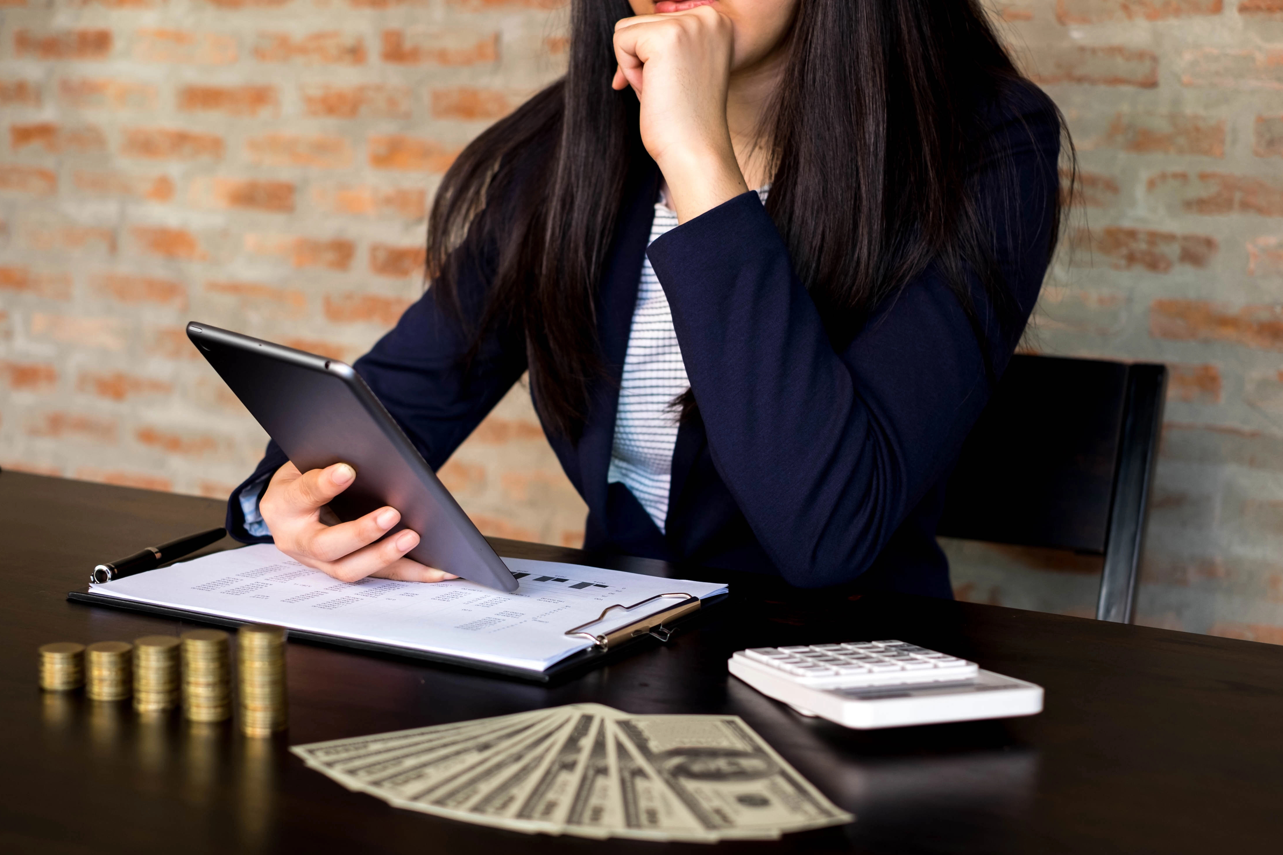 A business owner looking at a tablet.