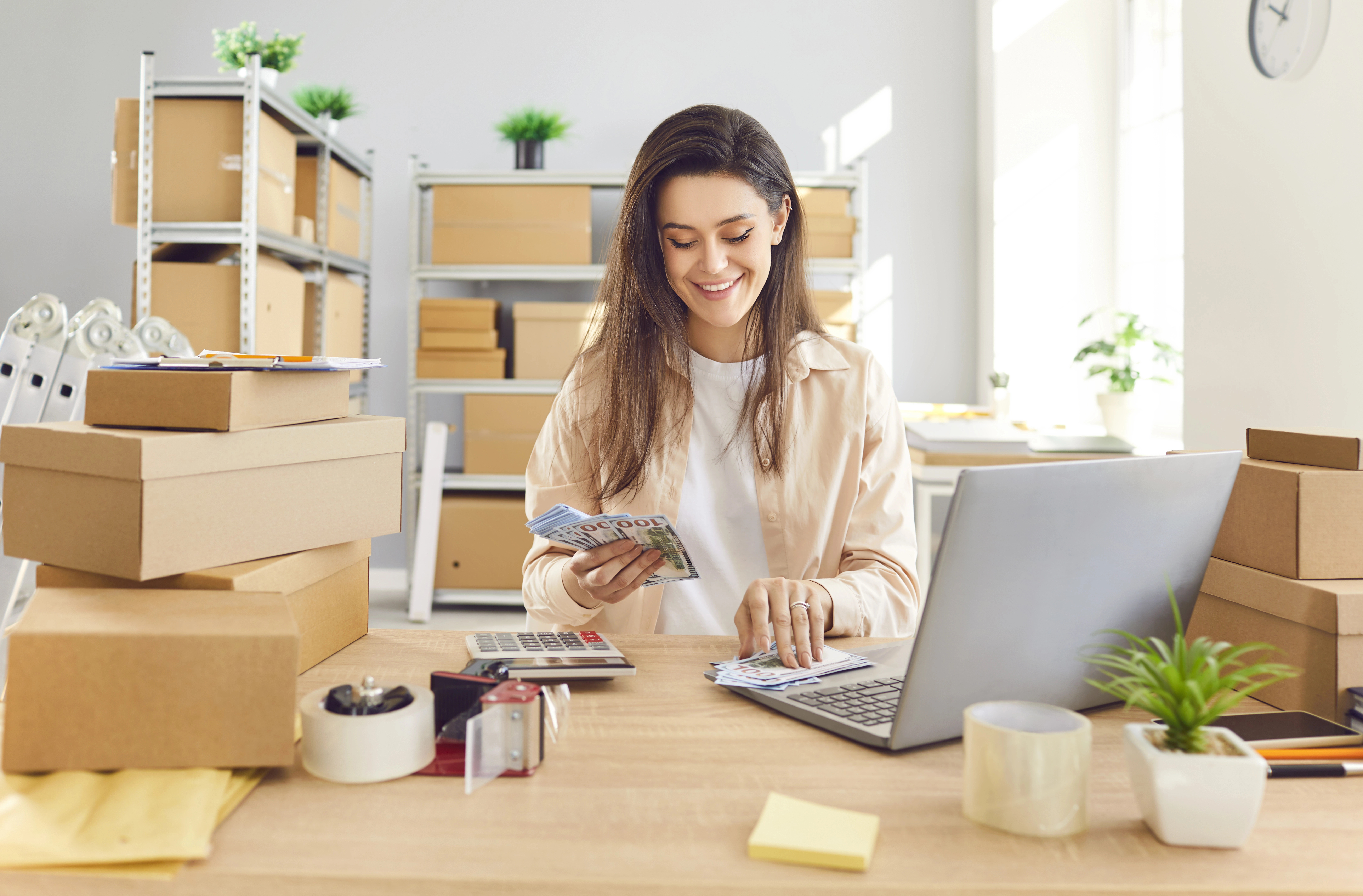 A small business owner counting cash for her business.