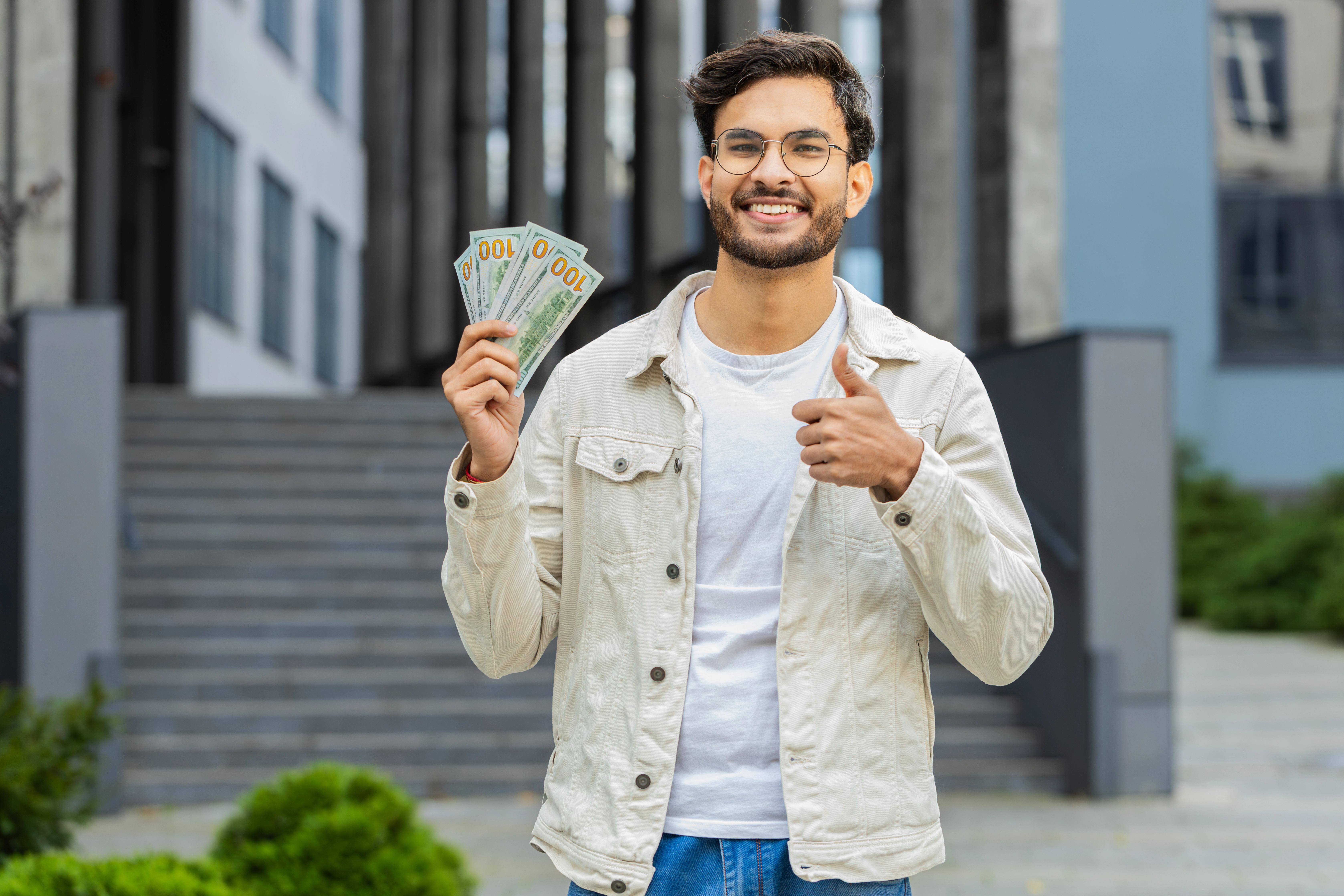 A small business owner holding cash after getting funding
