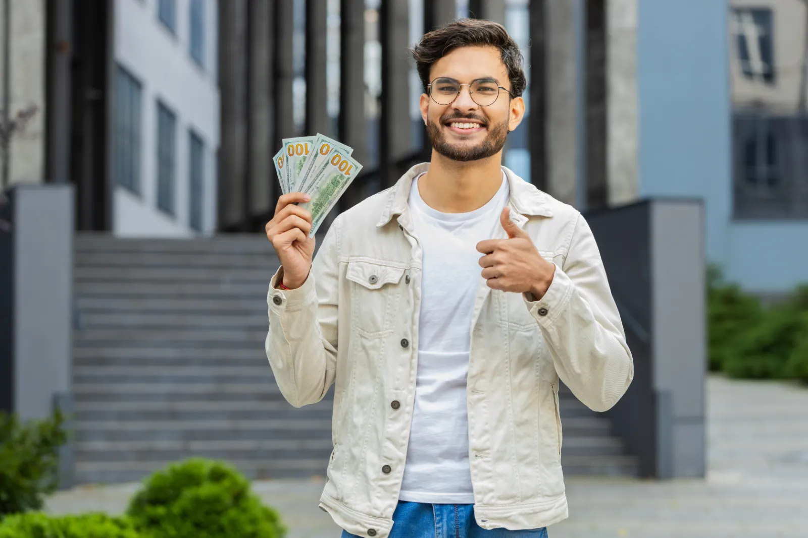A small business owner holding cash after getting funding