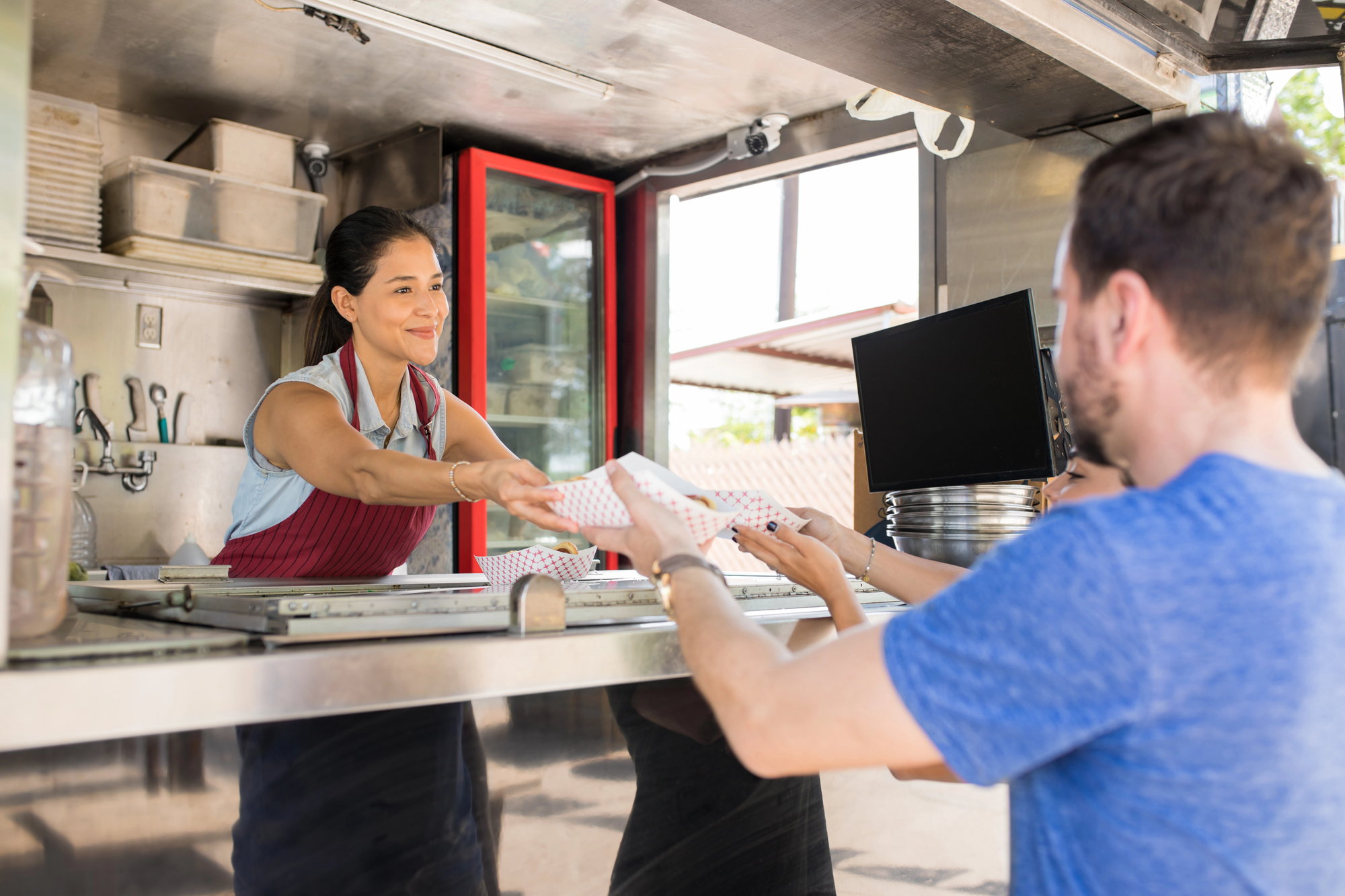 newly opened food truck serving a customer