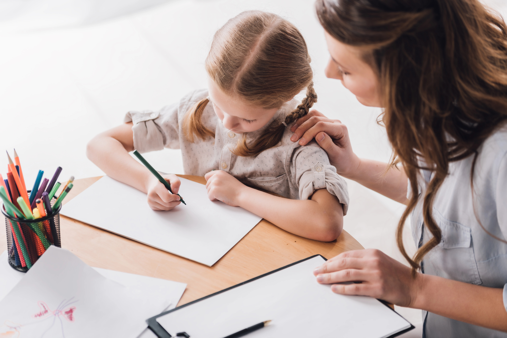freelance tutor providing a one-on-one lesson to a young student in a rented classroom