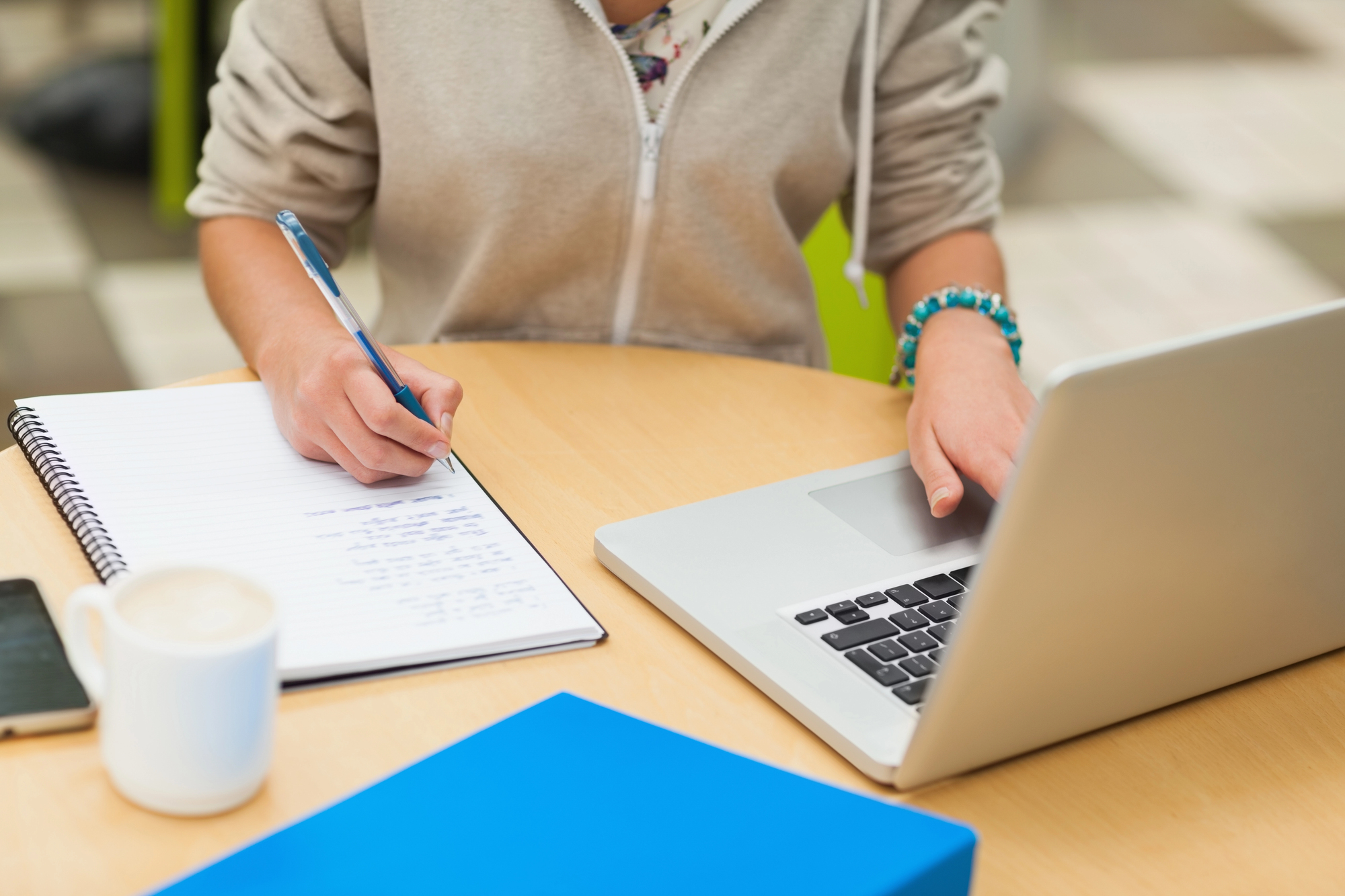 freelancer jotting down the pros and cons of a merchant cash advance