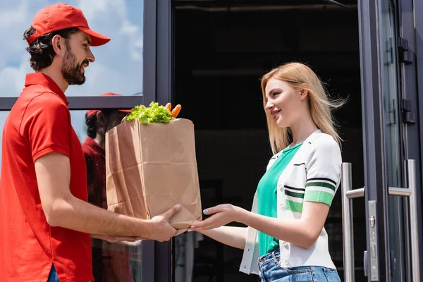 independent delivery driver giving the customer their ordered produce