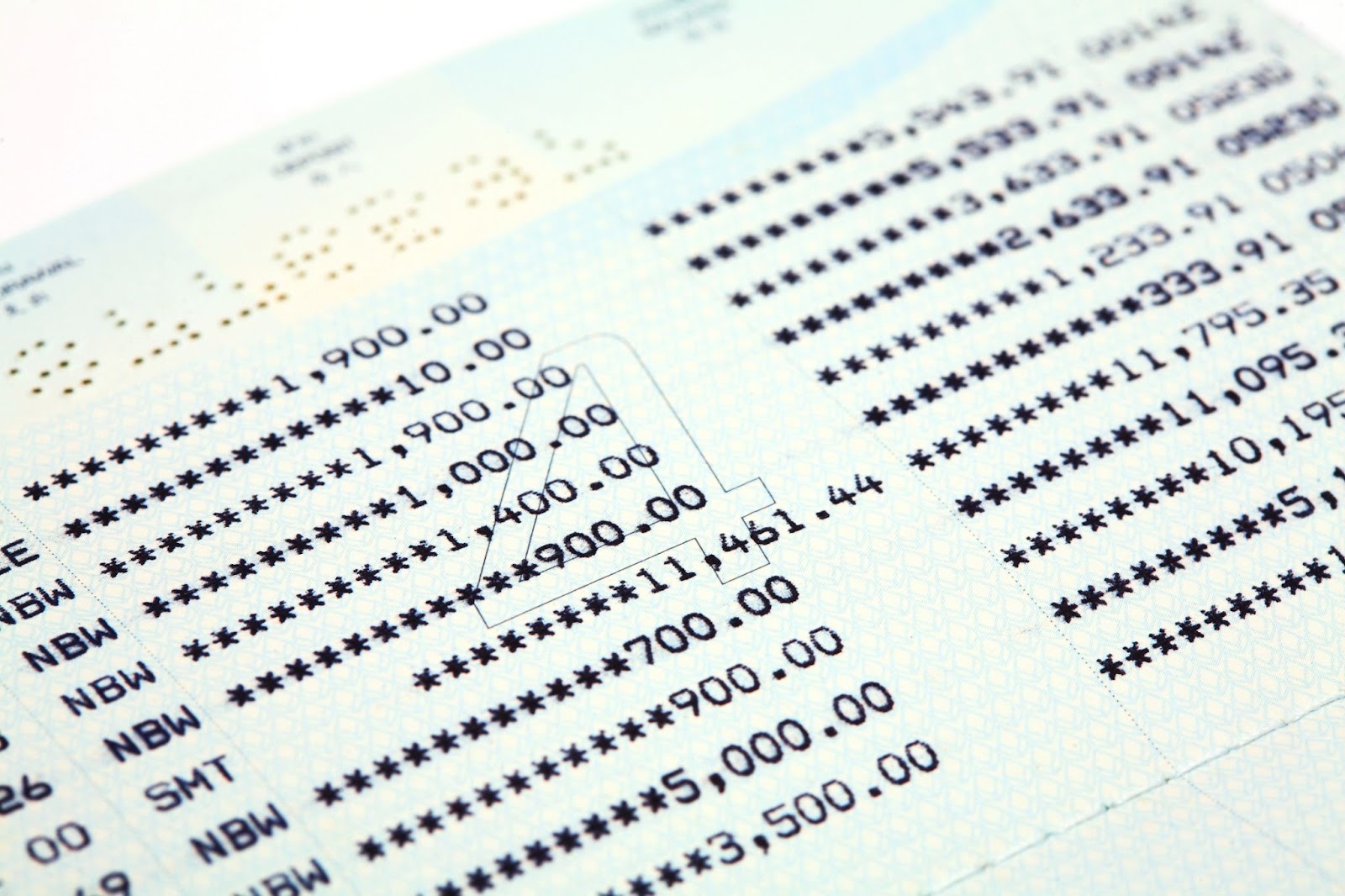 Close-up of a bank statement showing account balances and transactions.