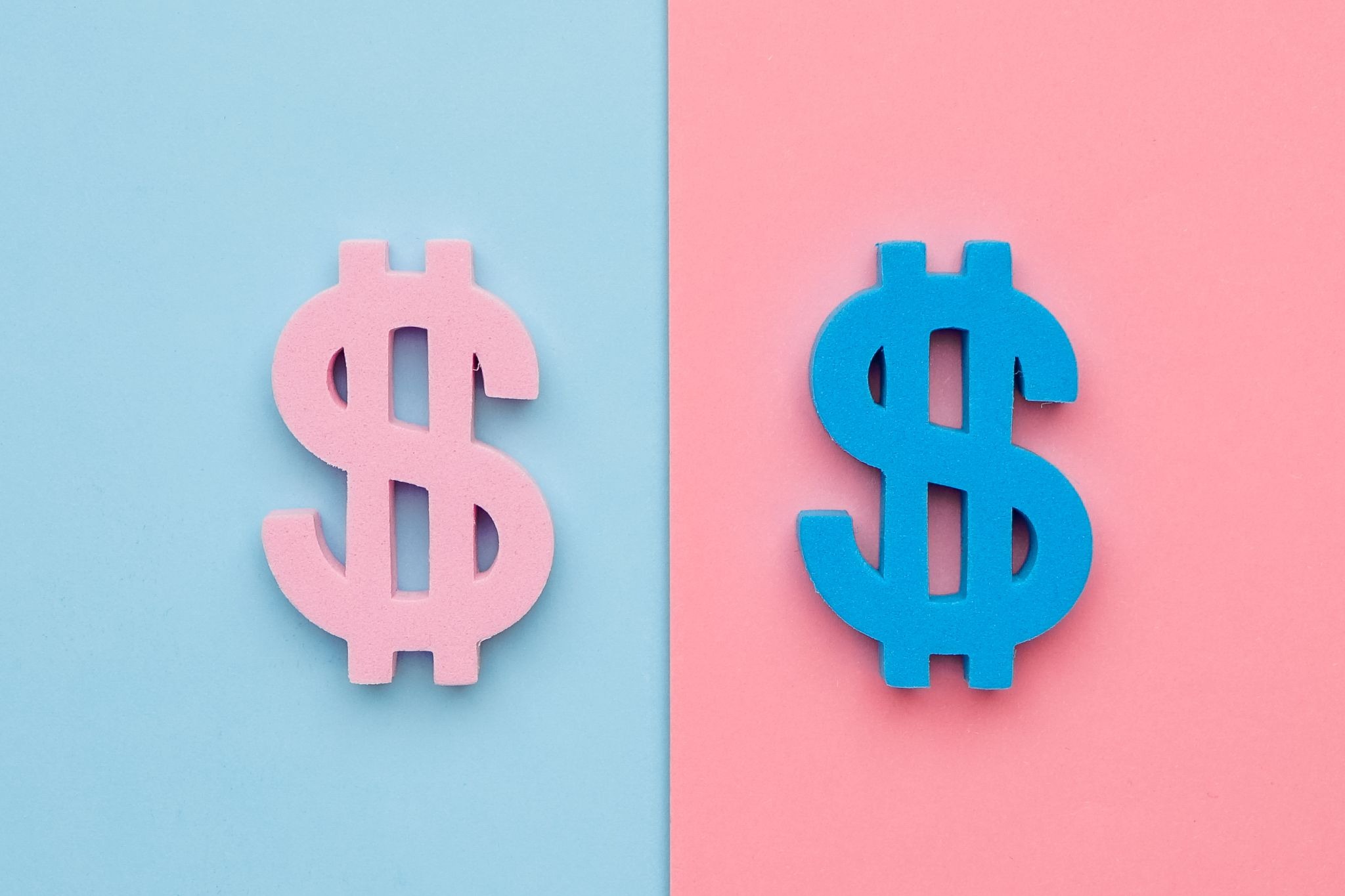 Pink and blue dollar symbols on a split pastel background.