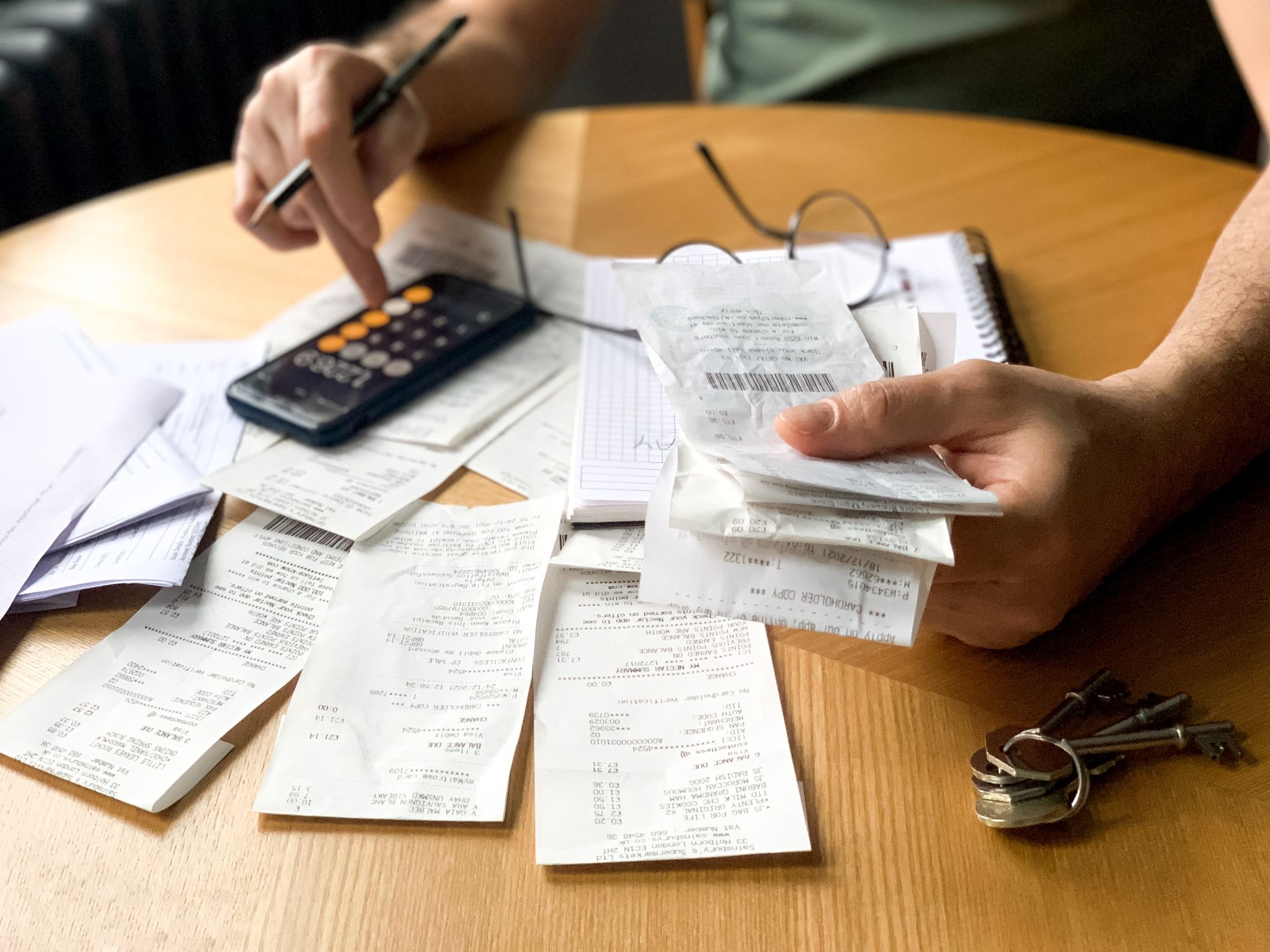 freelancer computing their total costs using a calculator
