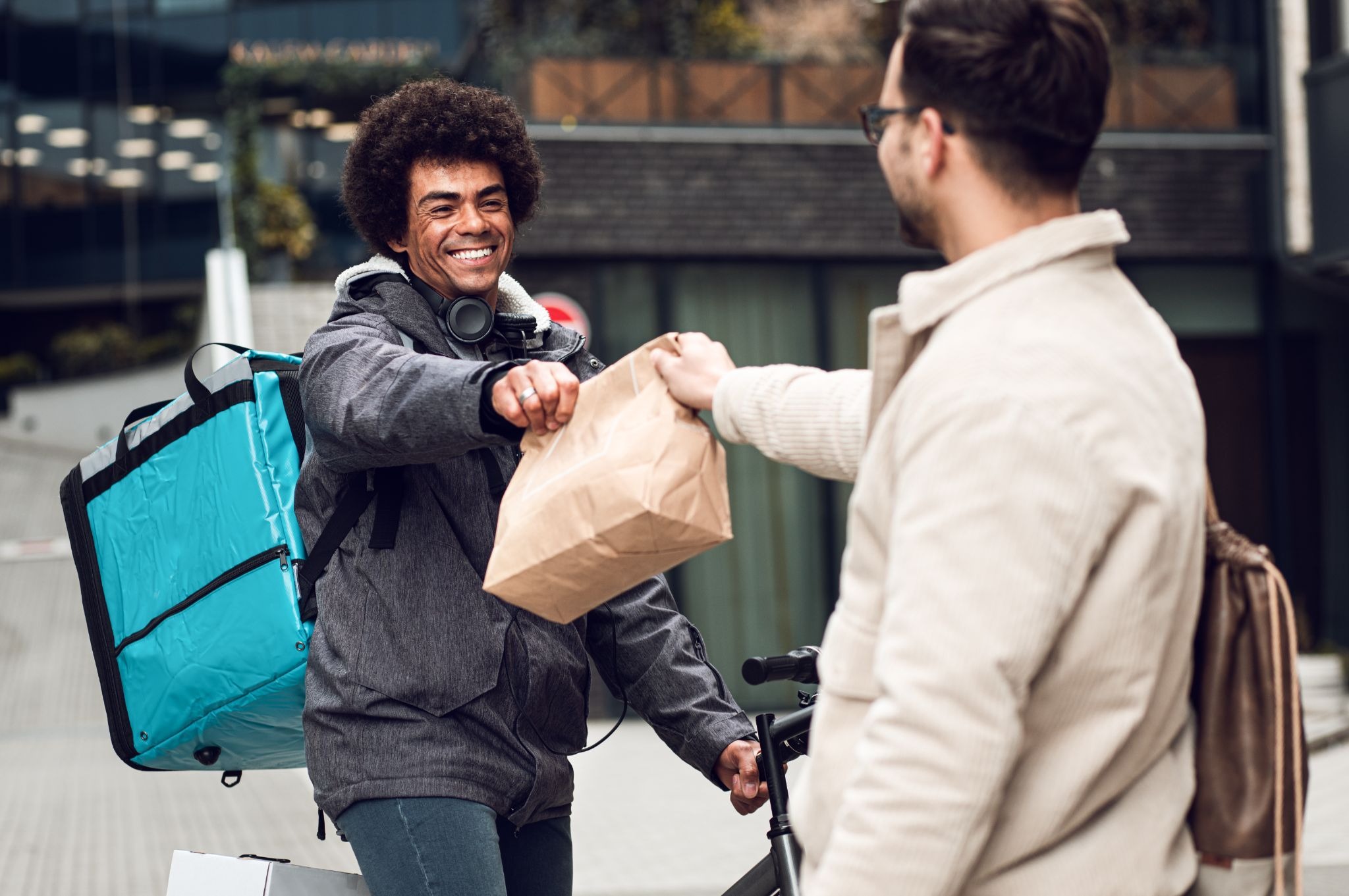 a happy and confident independent contractor delivering using a bike
