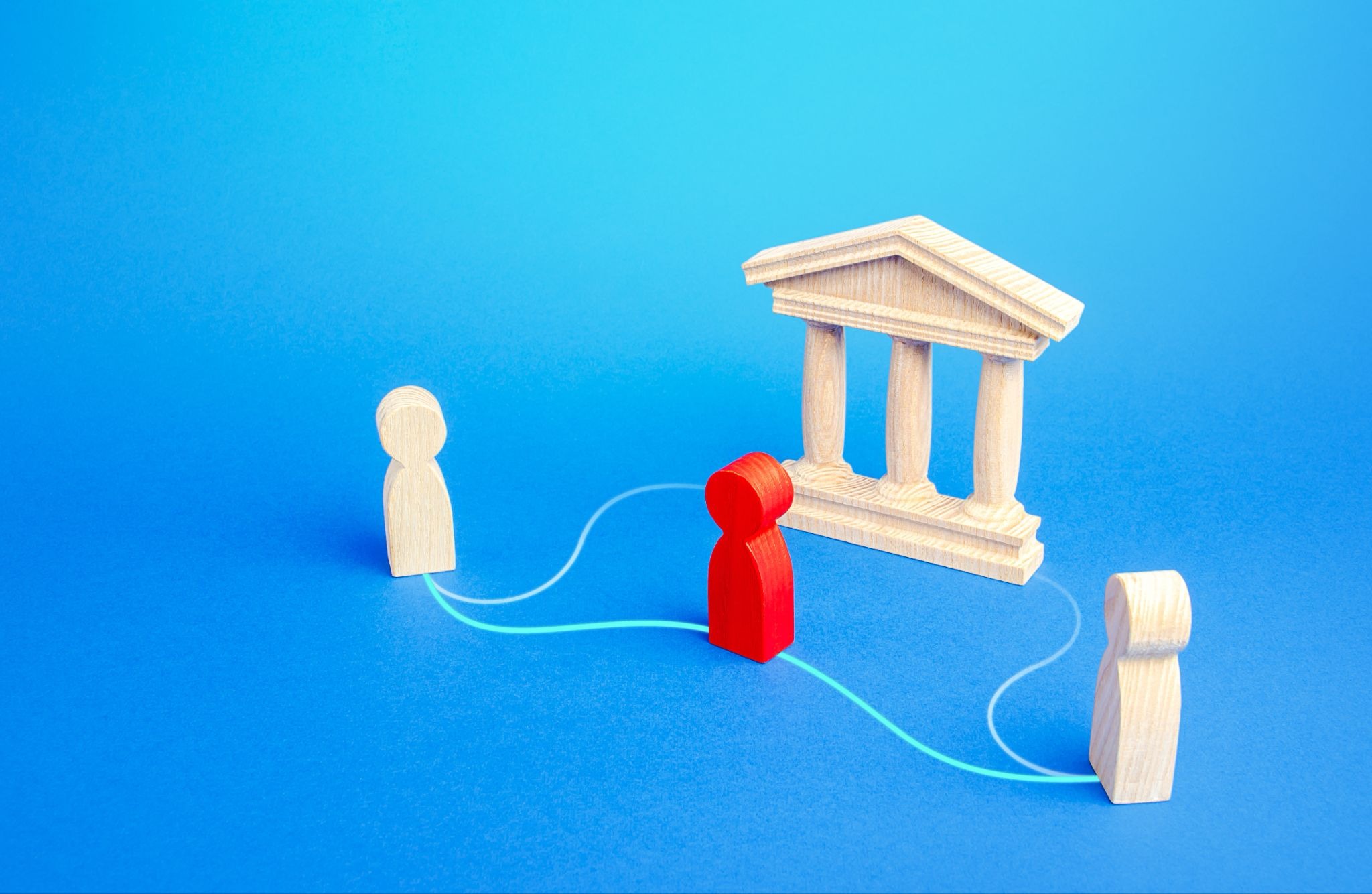 Wooden figures connected by lines, with one highlighted in red near a bank building
