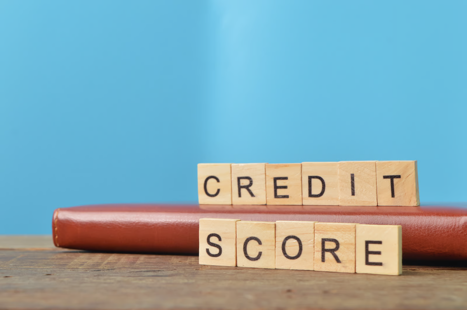 Close-up of wooden blocks spelling “credit score” on a flat surface