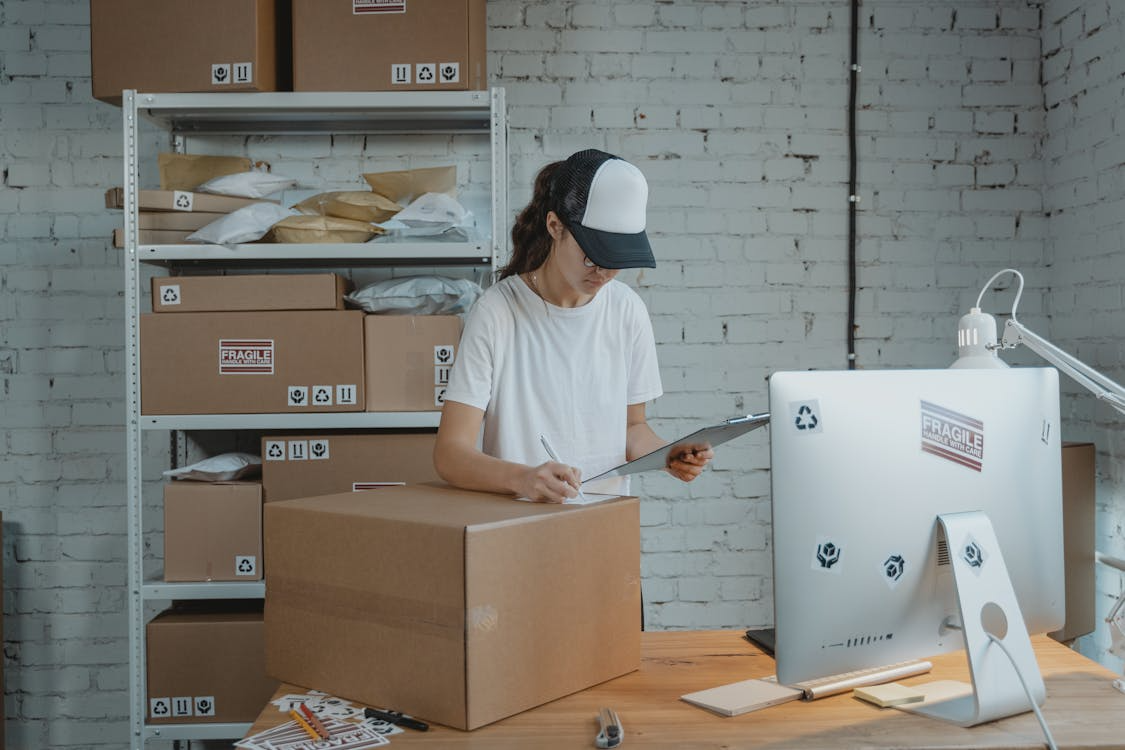 Etsy seller preparing their shipment while in the office