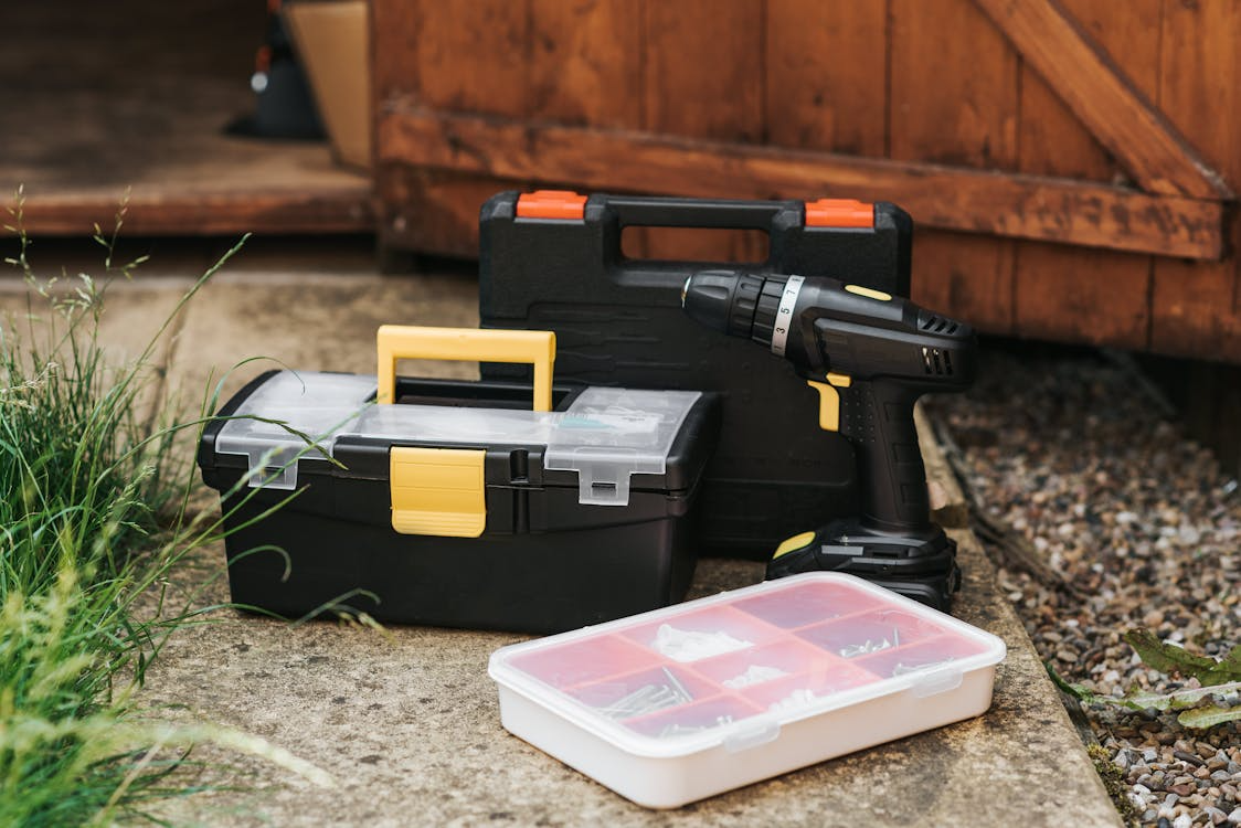 a TaskRabbit tasker’s toolbox and other supplies on top of the pavement
