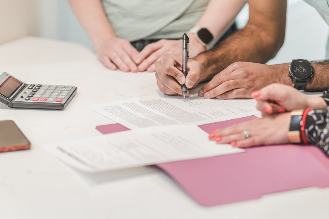 Gig worker signing a health insurance they chose after reading about the choices online
