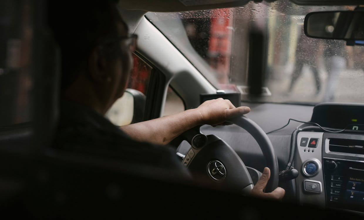 Rideshare driver driving their car while raining
