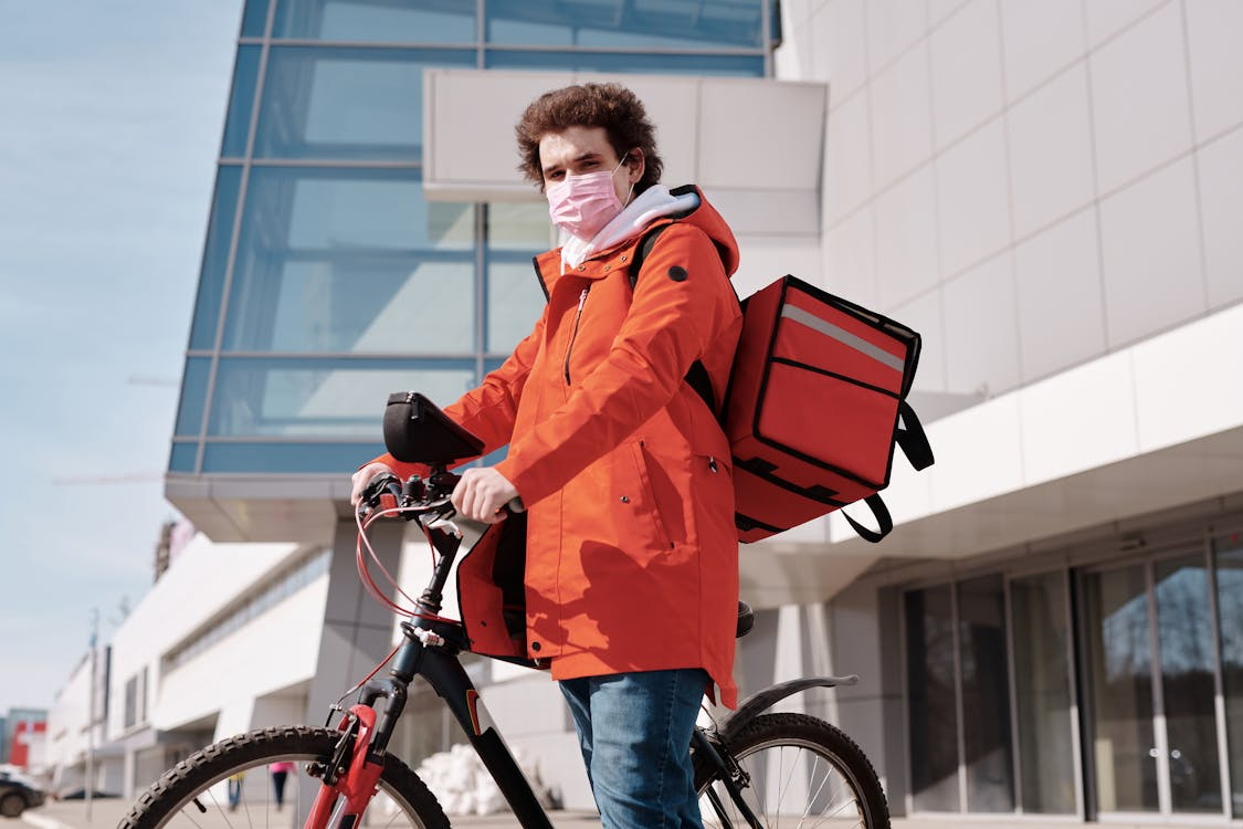 A delivery driver travels to a customer’s address to deliver a food order
