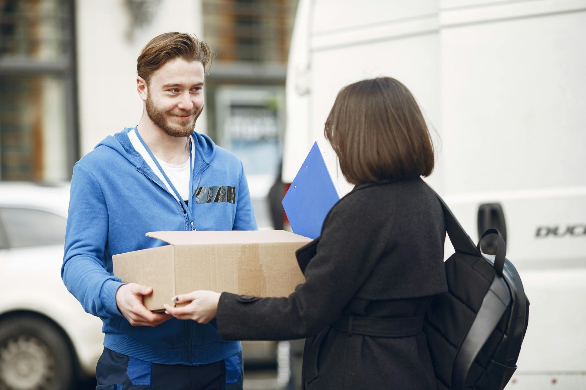  A delivery driver receives a package from a customer for shipment