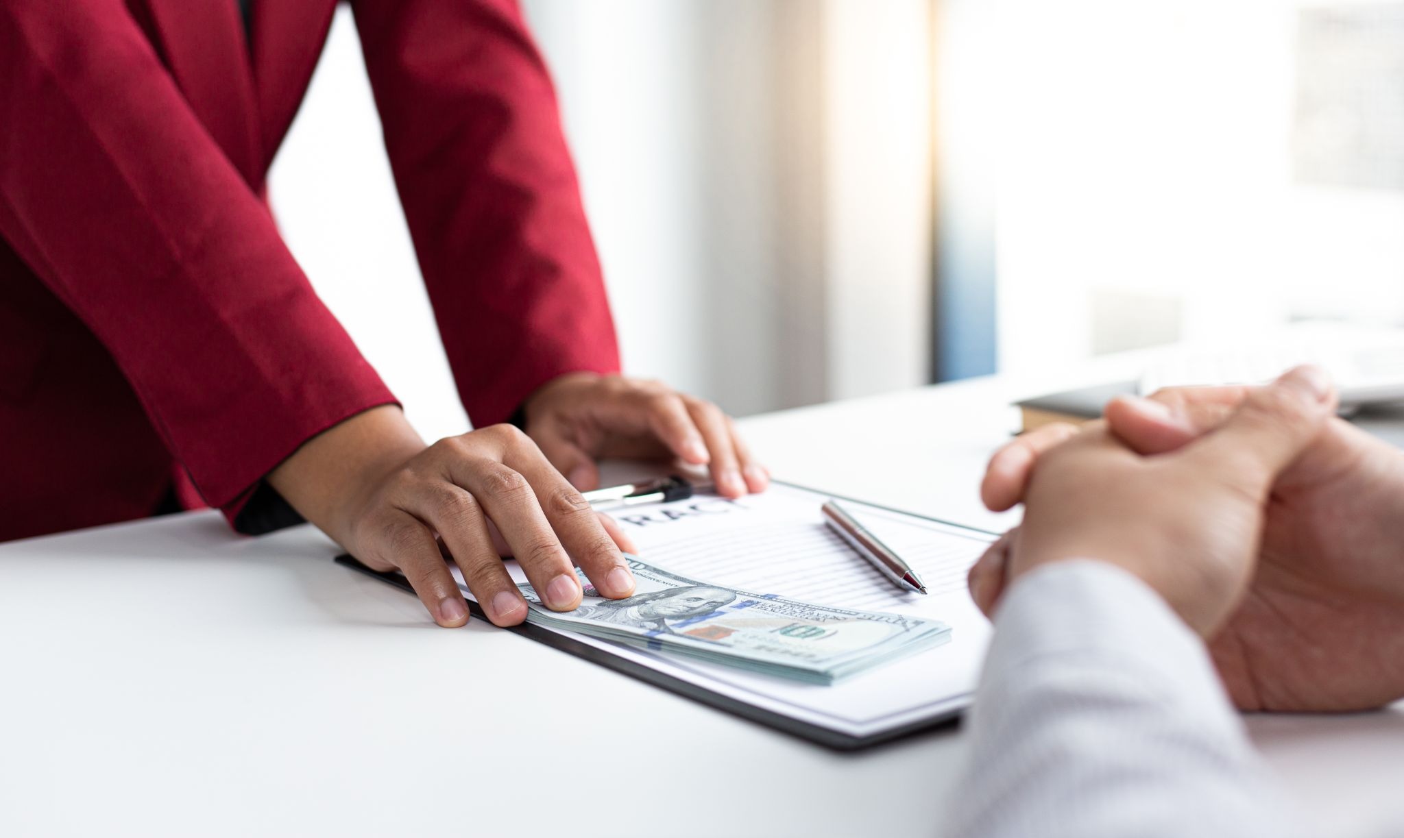 Freelancer meeting with a bank representative to apply for a business loan.