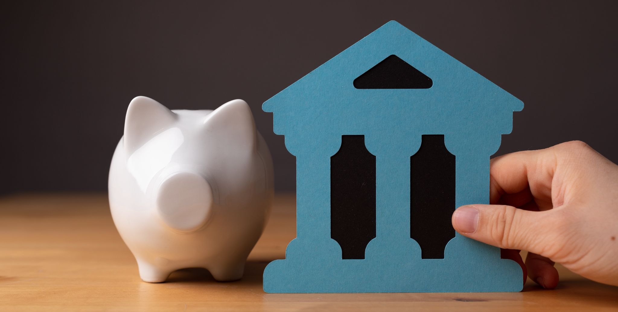 Traditional bank savings concept with a piggy bank and bank building icon