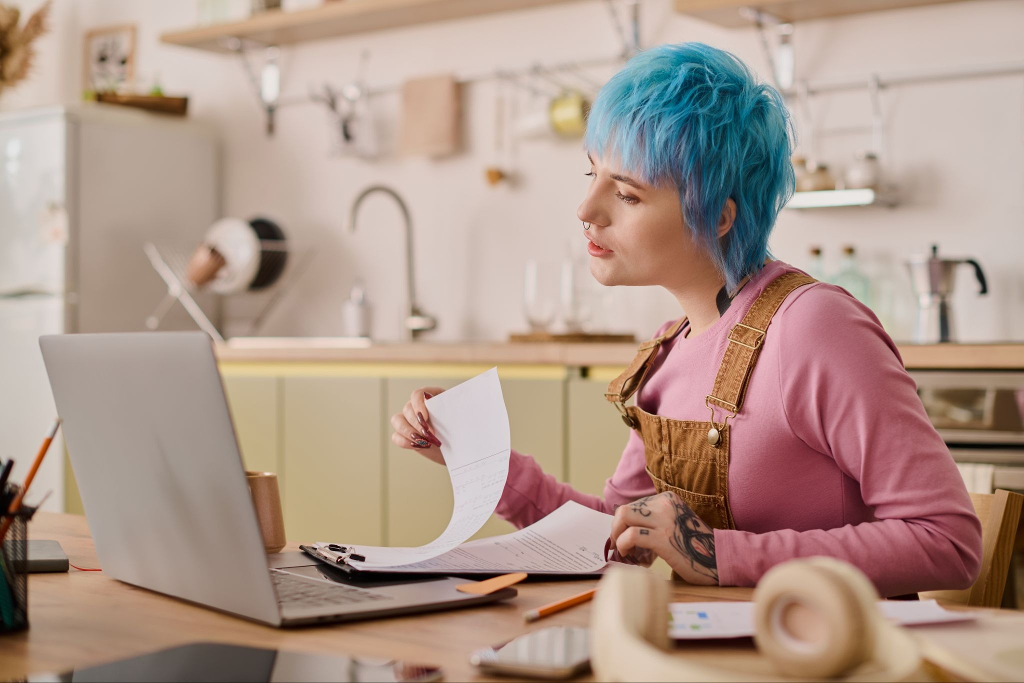 Gig worker reviewing insurance premium documents and expenses while working from a home office