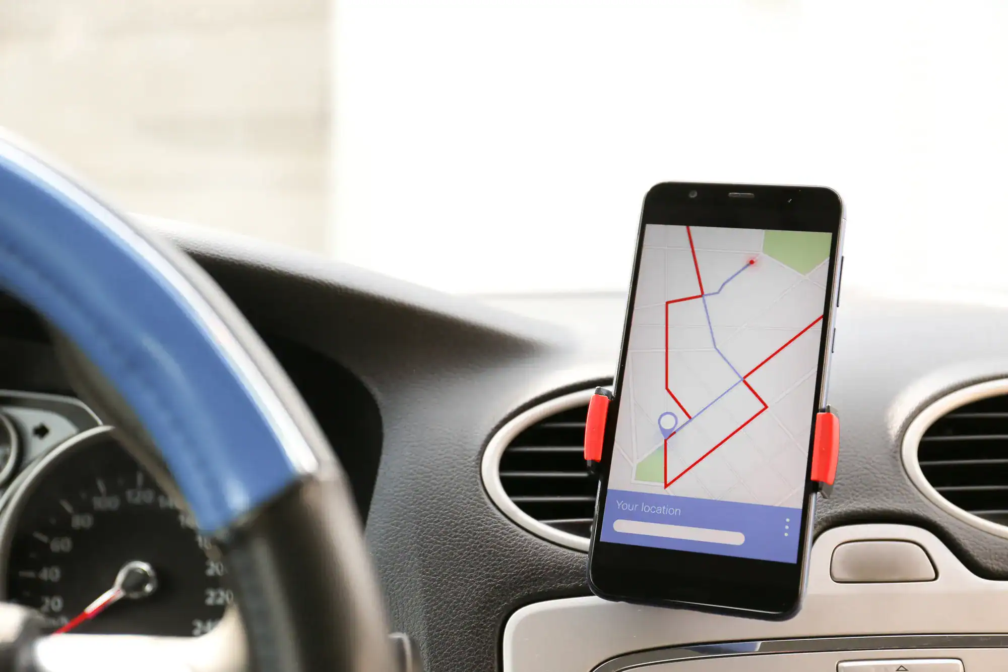  rideshare driver using a map app on their phone to guide them to their destination