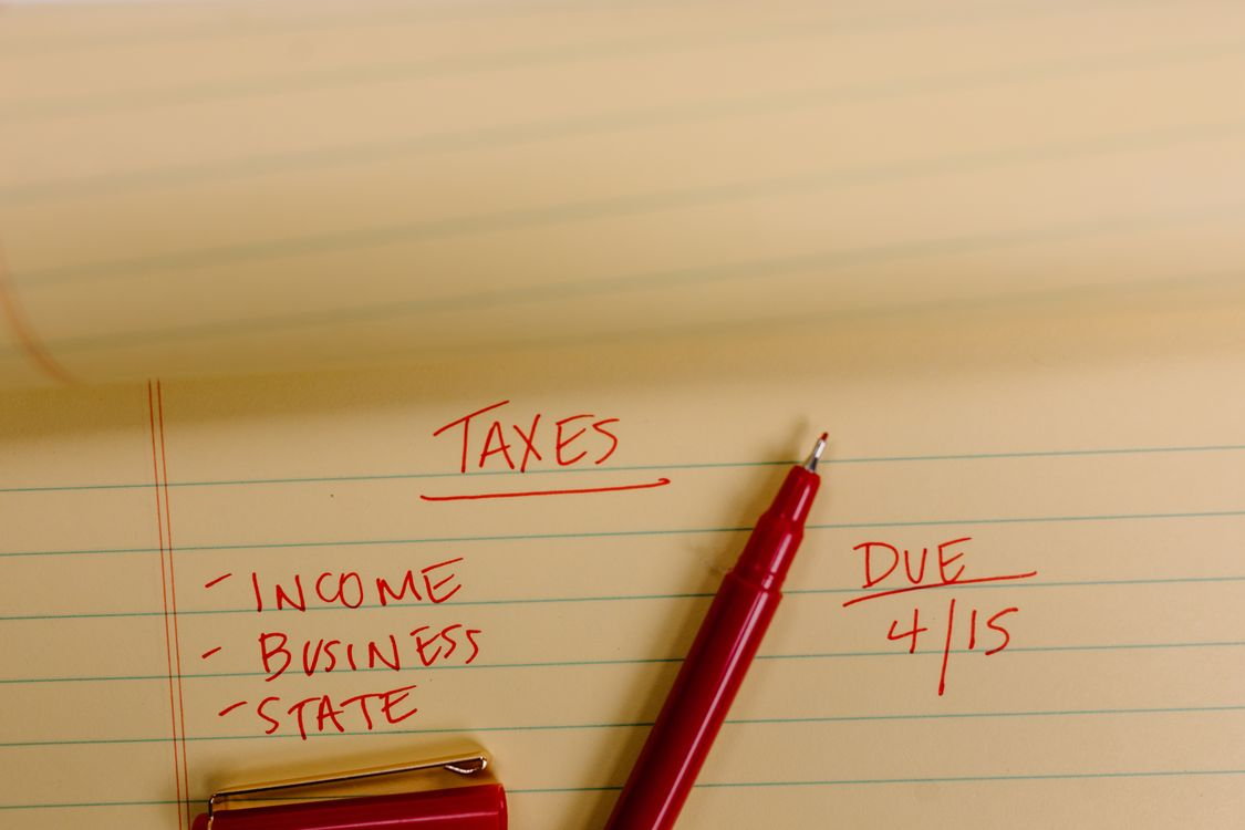 A notepad with a list of taxes to pay and their due dates 