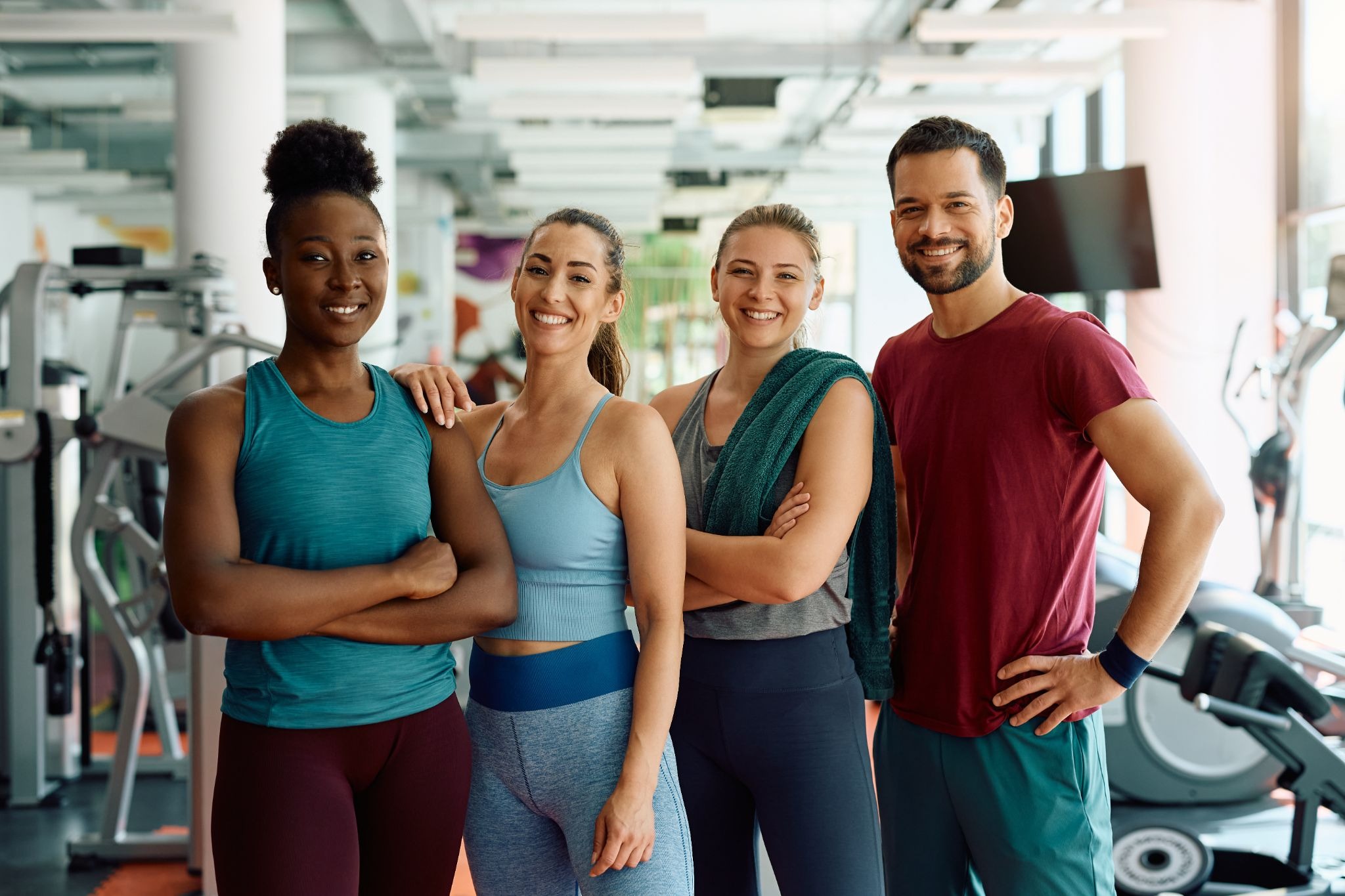 Freelance fitness coaches posing together in a gym