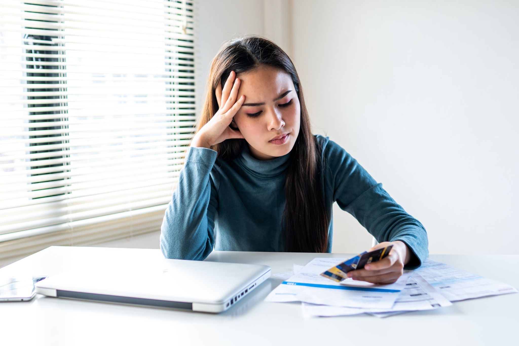 Gig worker reviewing expenses and credit card statements while working to build a stronger credit history