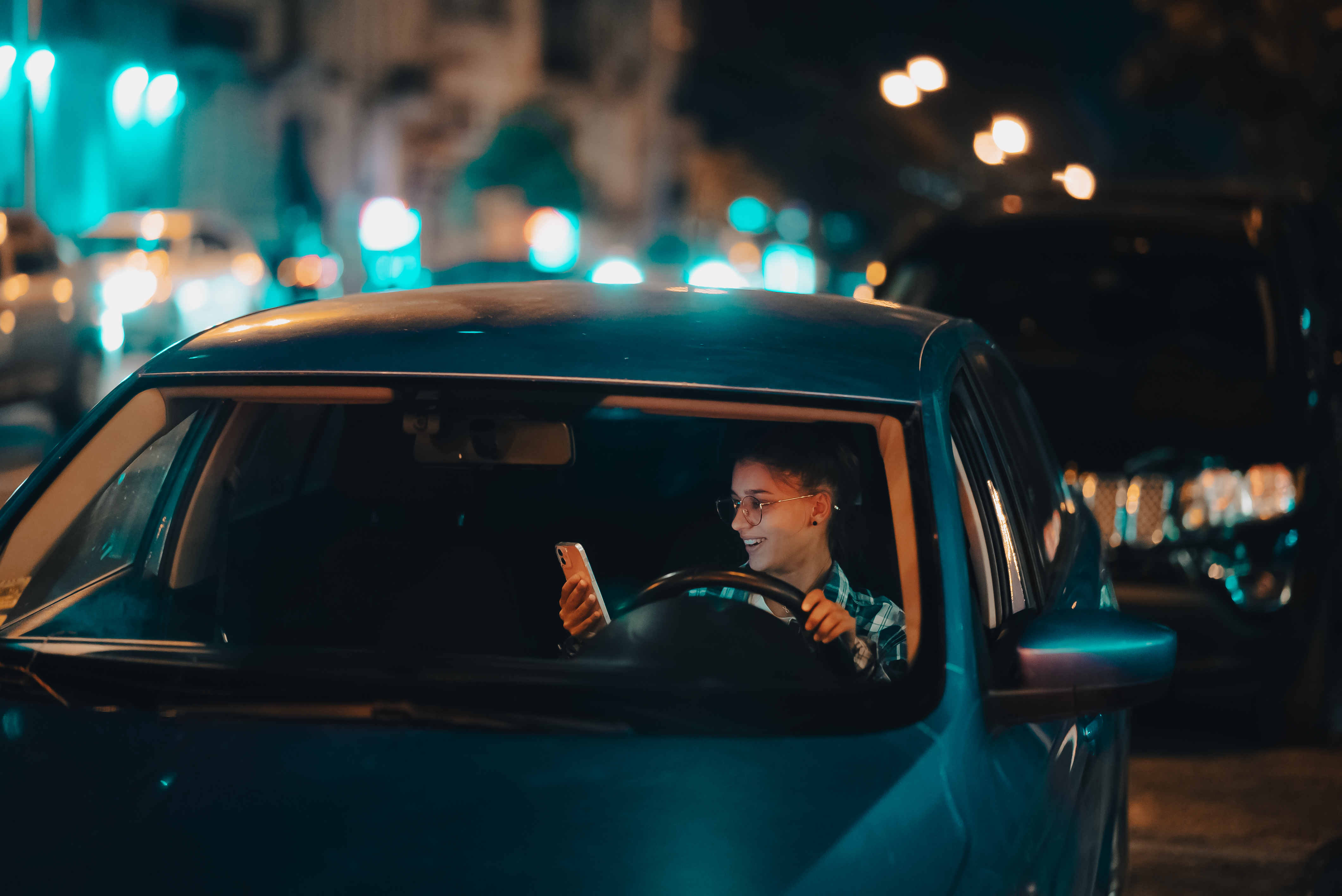 GoPuff delivery driver checking the app between late-night deliveries while earning flexible income during an evening shift.