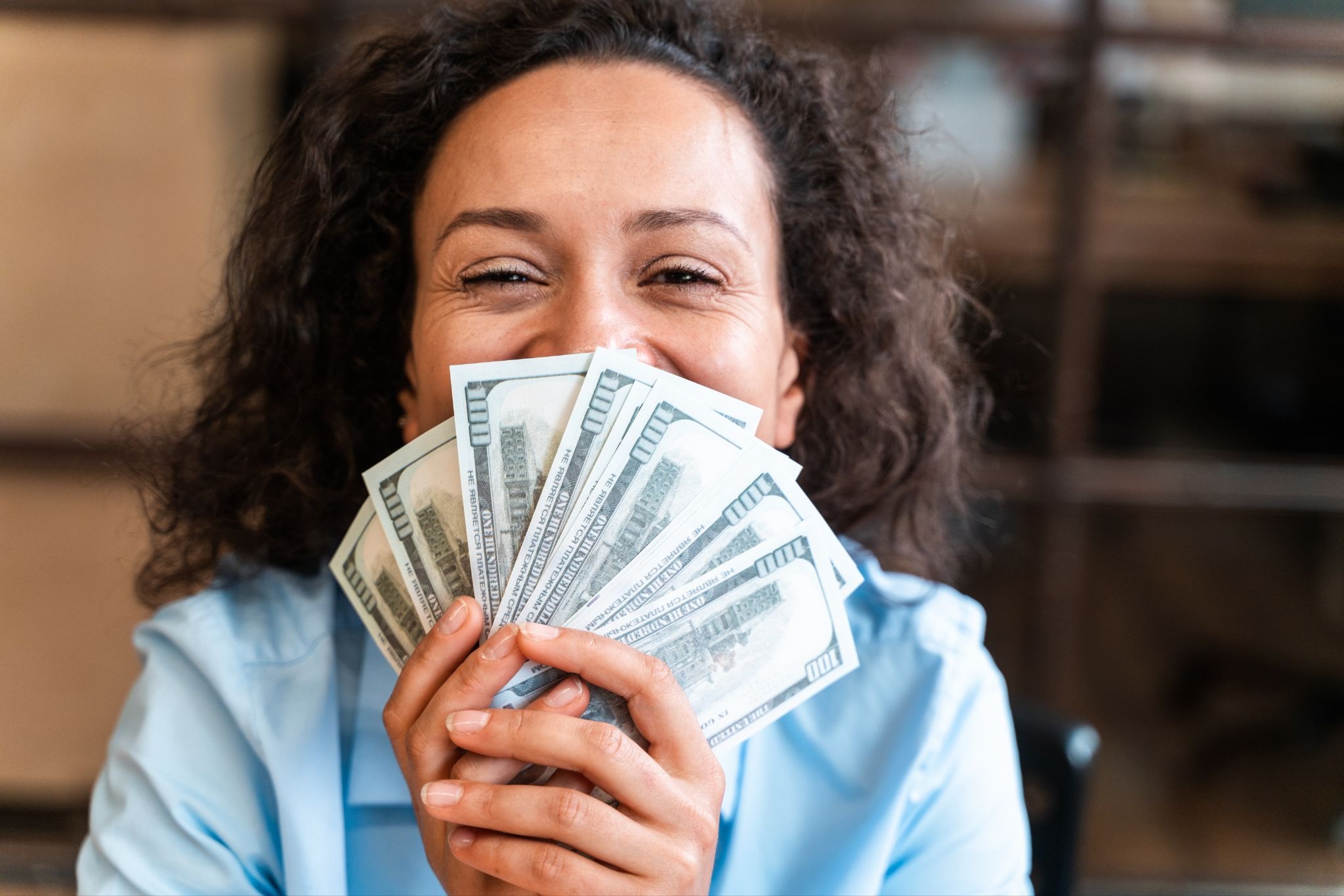 Gig worker celebrating earnings while exploring financing options tailored to different types of freelance and contract work.