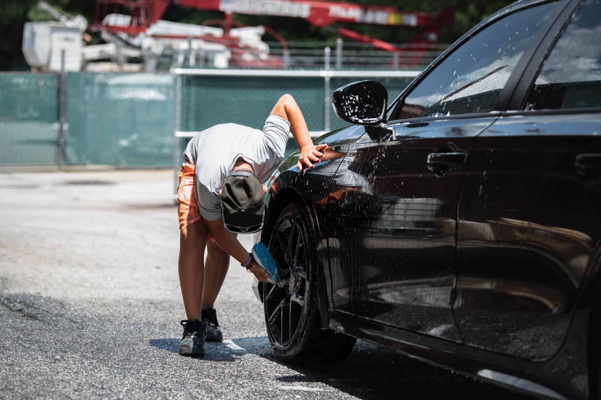 A vehicle being cleaned at a car wash before its next Turo booking