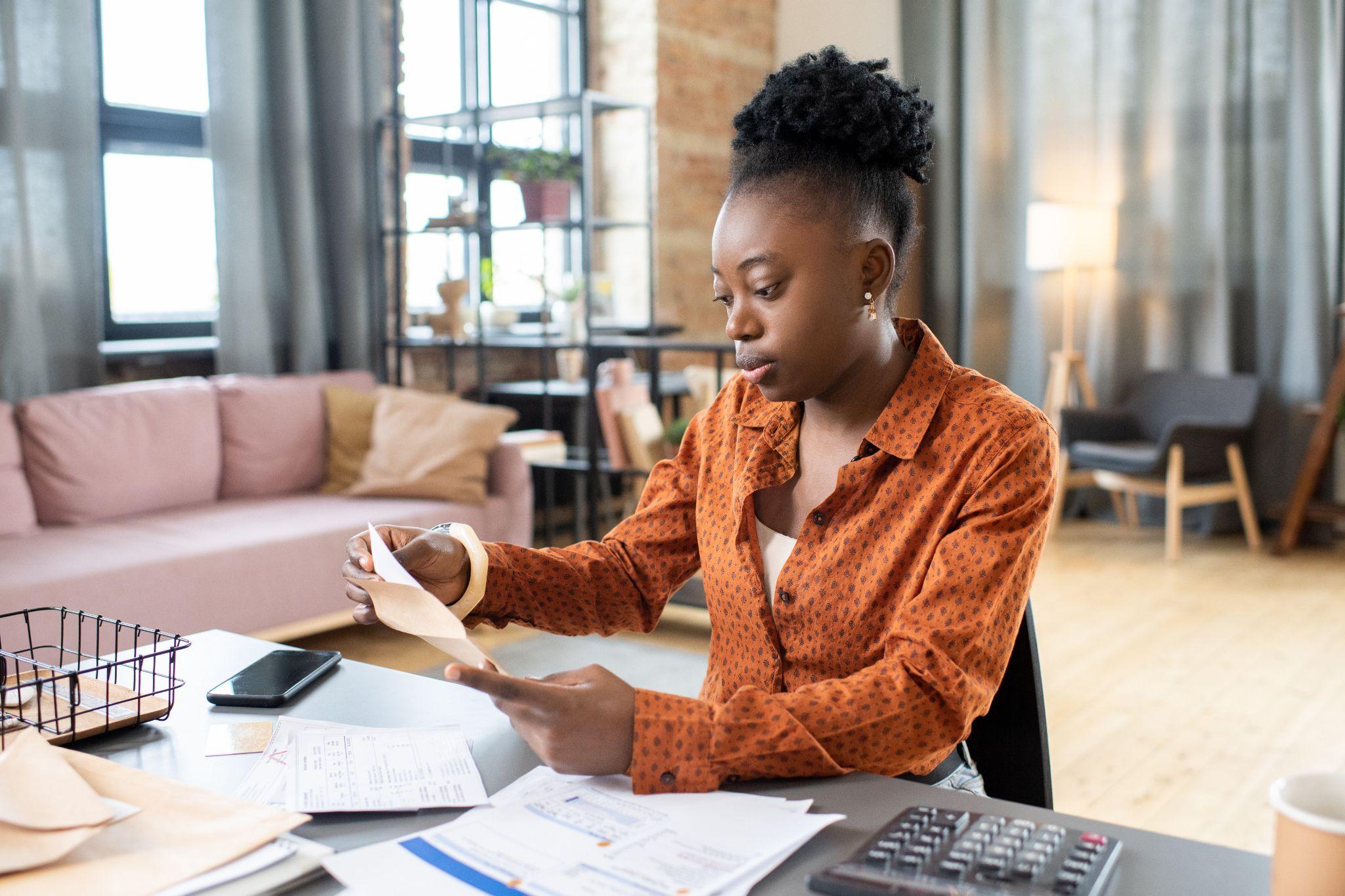 Freelance translator reviewing bills and managing her finances.