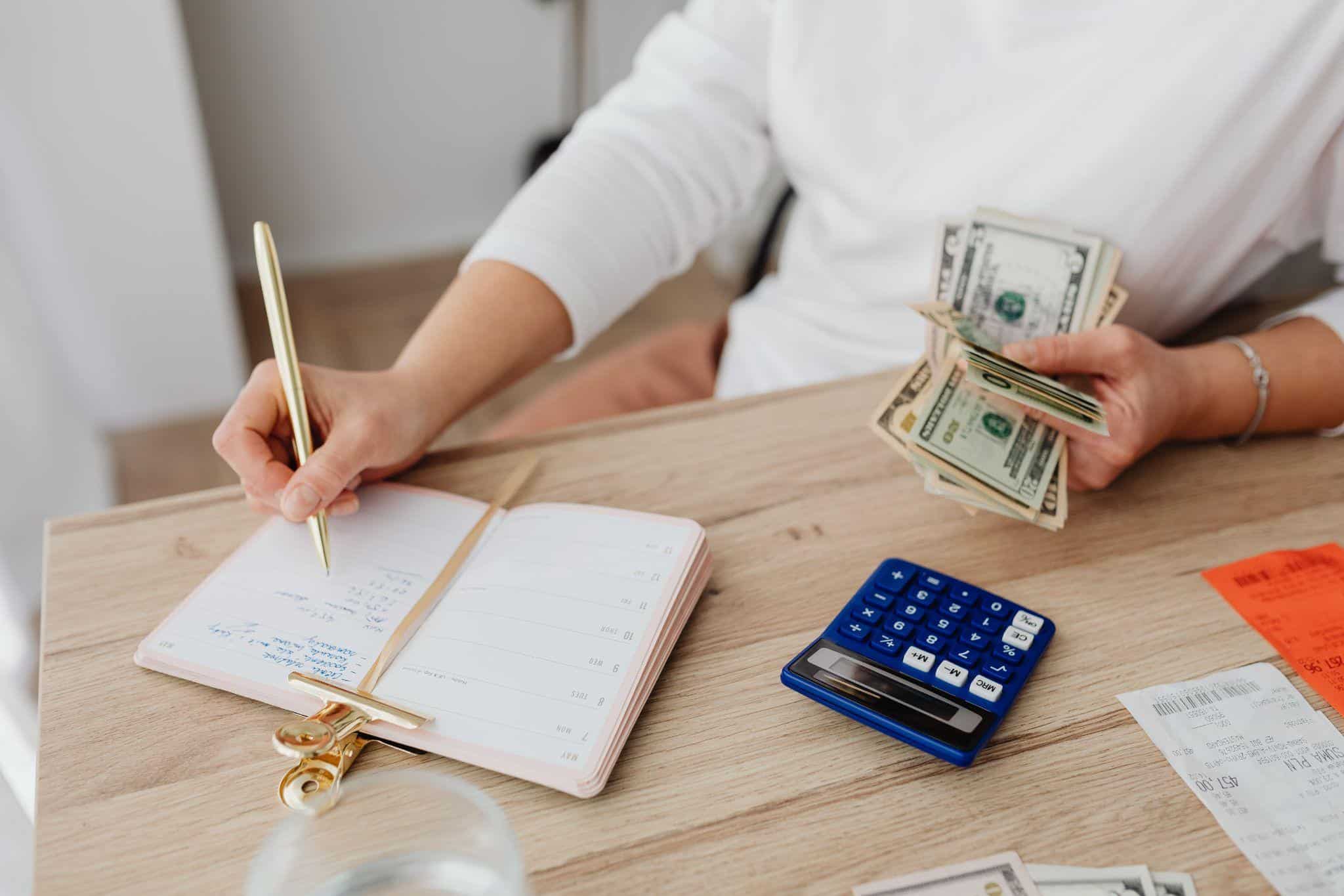An Instacart shopper counting cash earnings and setting aside savings from a strong holiday week
