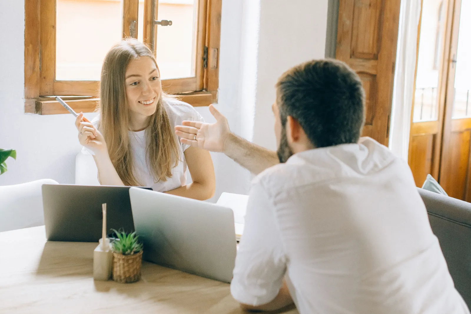 Two freelancers working under the same LLC discussing ideas during a meeting for an upcoming client project