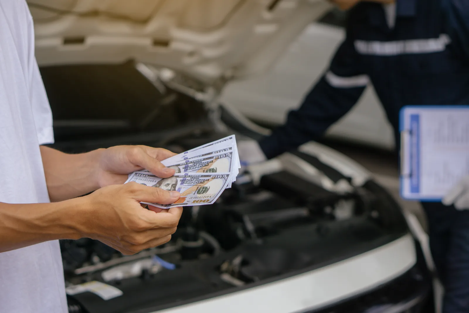 Uber driver paying cash for a car repair